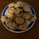 A picture showing two handed oatmeal raisin cookies